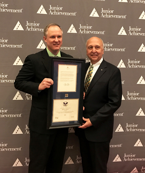Aaron Miner, operations manager of LyondellBasell's Morris, Illinois, Complex, accepts the US President's Volunteer Service Award from Jack E. Kosakowski, Junior Achievement USA President and CEO, for the company's donation of more than 5,000 volunteer hours to JA programs.