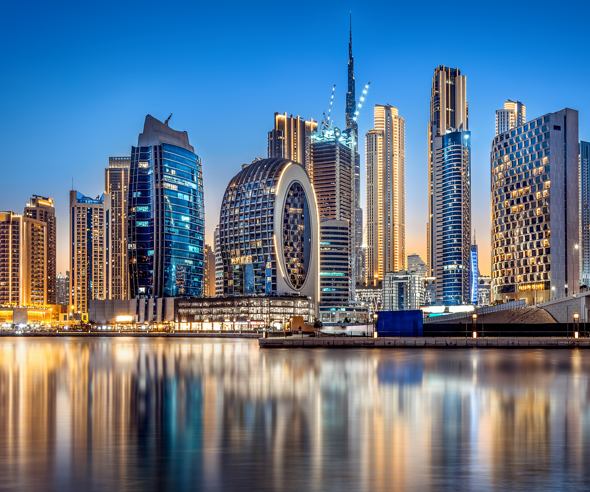 Night view of Dubai skyline with illuminated modern skyscrapers