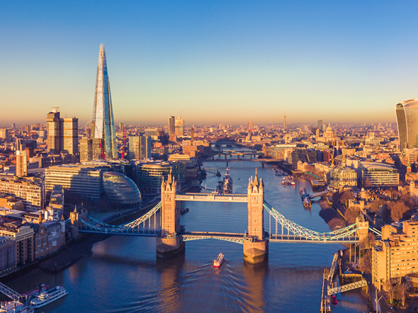 Aerial view of London at sunrise featuring Tower Bridge