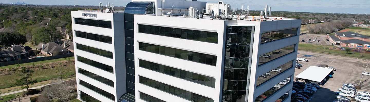 Exterior view of a modern office building with nearby parking and surrounding neighborhood