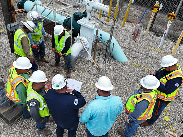 Safety briefing among workers at the pipeline facility