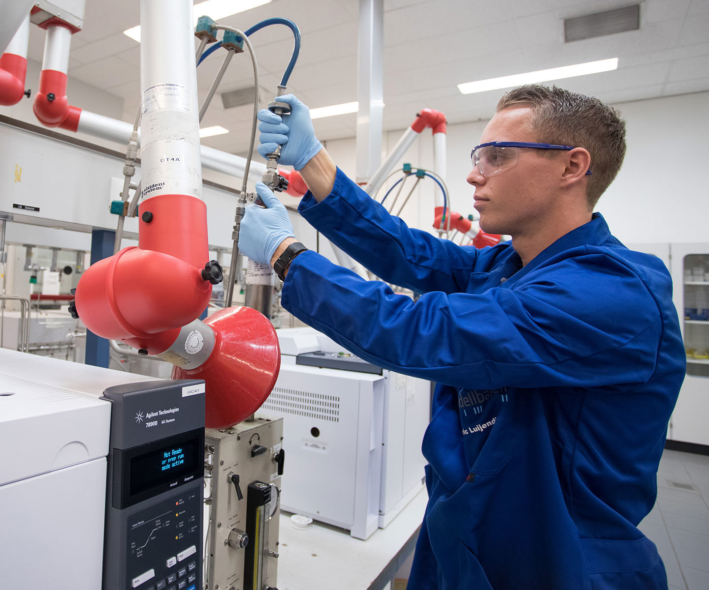 LYB employee in a laboratory adjusts tubing and controls on analytical equipment